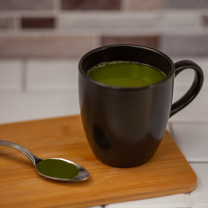 Organic Matcha mixed with water in a cup